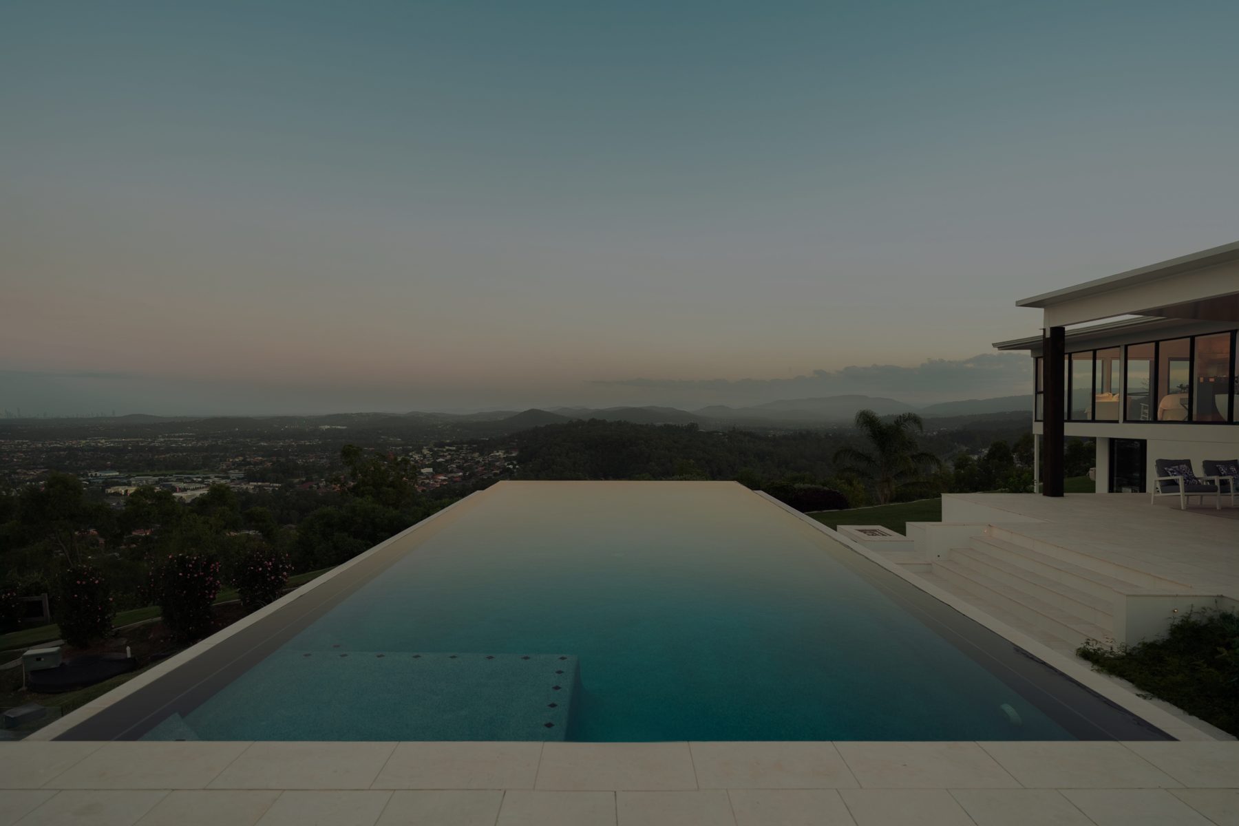 Infinity pool at dusk overlooking the valley