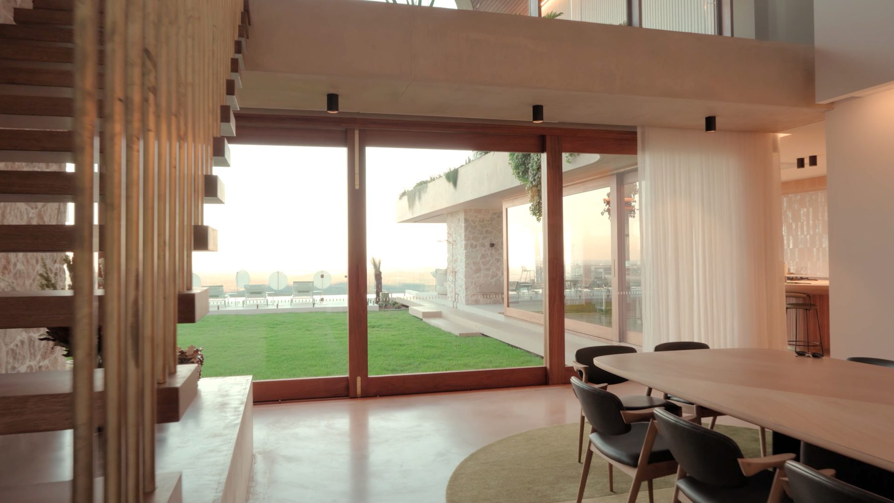 Interior living space opening to the water, filmed by RISE Realty Media